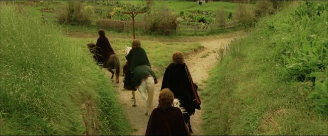 a still from Lord of the Rings of the Hobbits on horseback leaving the shire