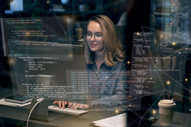 person sitting at computer writing code